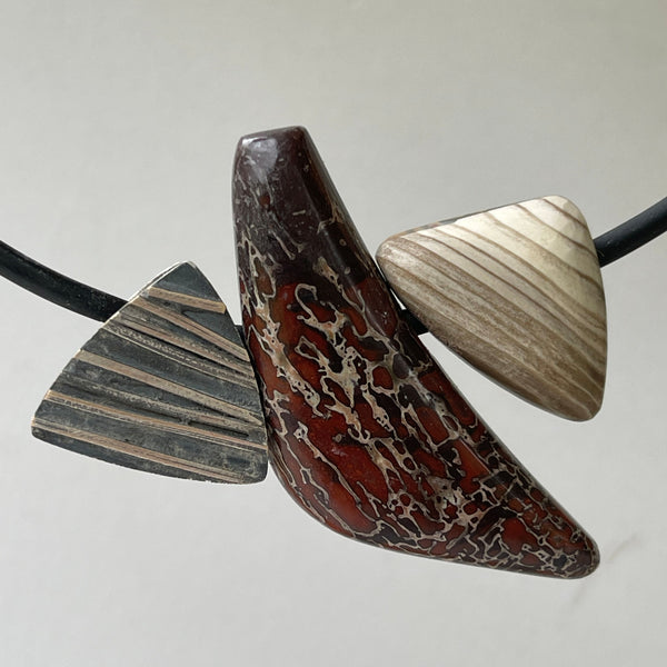 ustome Cut Dinasaur Bone, Petrified Wood, Turkish Purple Jade, Cherry Creek Jasper  and hand made sterling silver bead Pendant