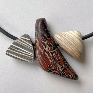 ustome Cut Dinasaur Bone, Petrified Wood, Turkish Purple Jade, Cherry Creek Jasper  and hand made sterling silver bead Pendant